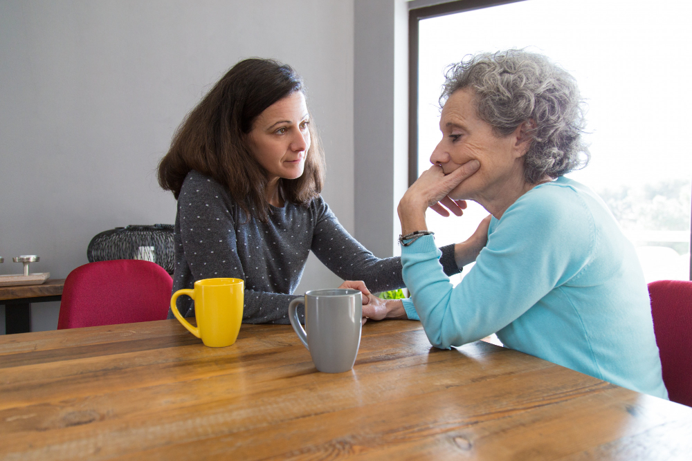 serious-young-woman-consoling-her-upset-senior-mother